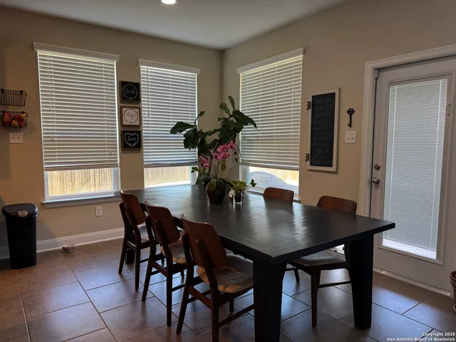 a view of a dining room with furniture and window