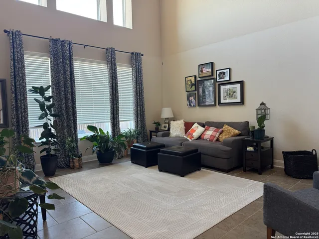 a living room with furniture windows and wooden floor