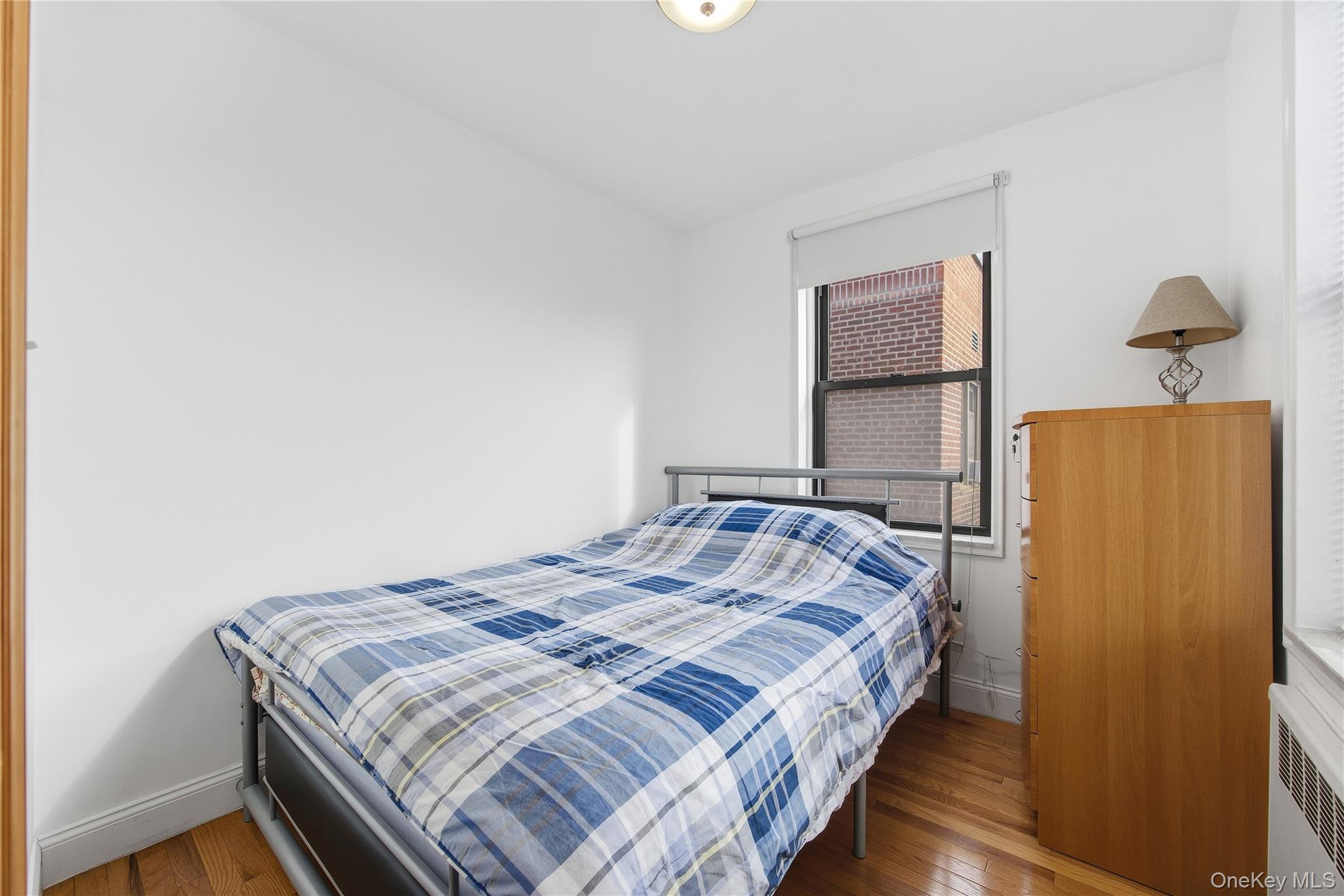 150-25 72nd Road, Unit 6A Queens, NY 11367 - Photo 11 of 13 a bedroom with a bed and wooden floor