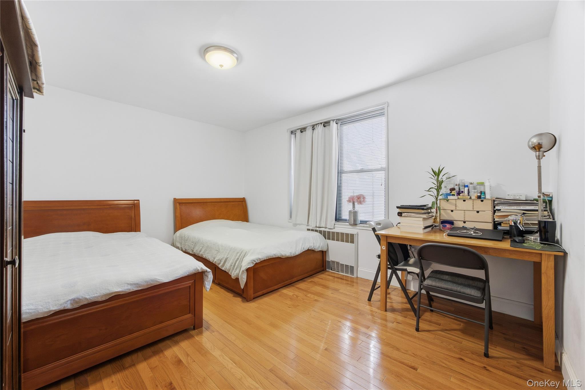 150-25 72nd Road, Unit 6A Queens, NY 11367 - Photo 13 of 13 a bedroom with two beds and a table