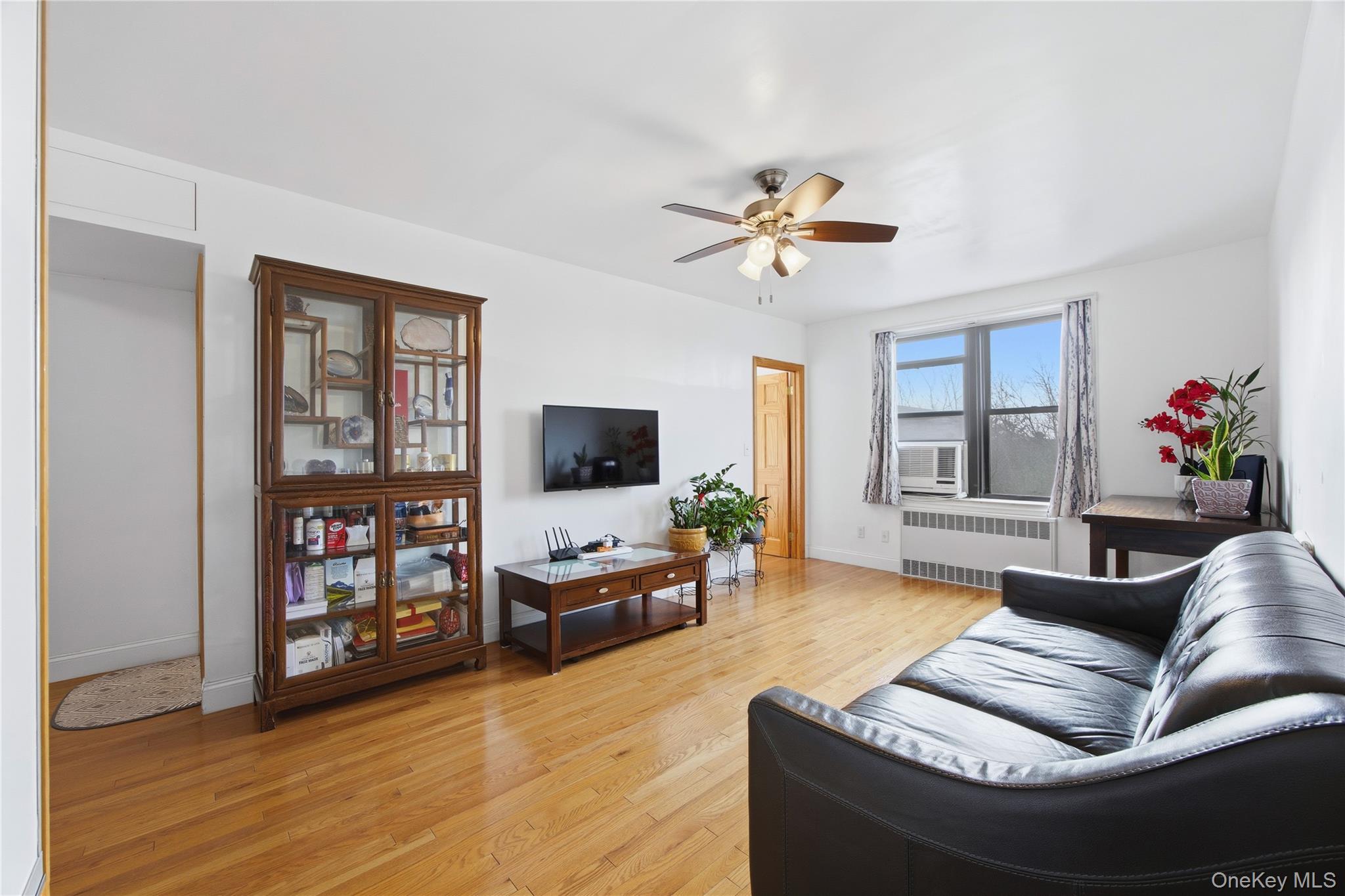 150-25 72nd Road, Unit 6A Queens, NY 11367 - Photo 3 of 13 a living room with furniture and a flat screen tv