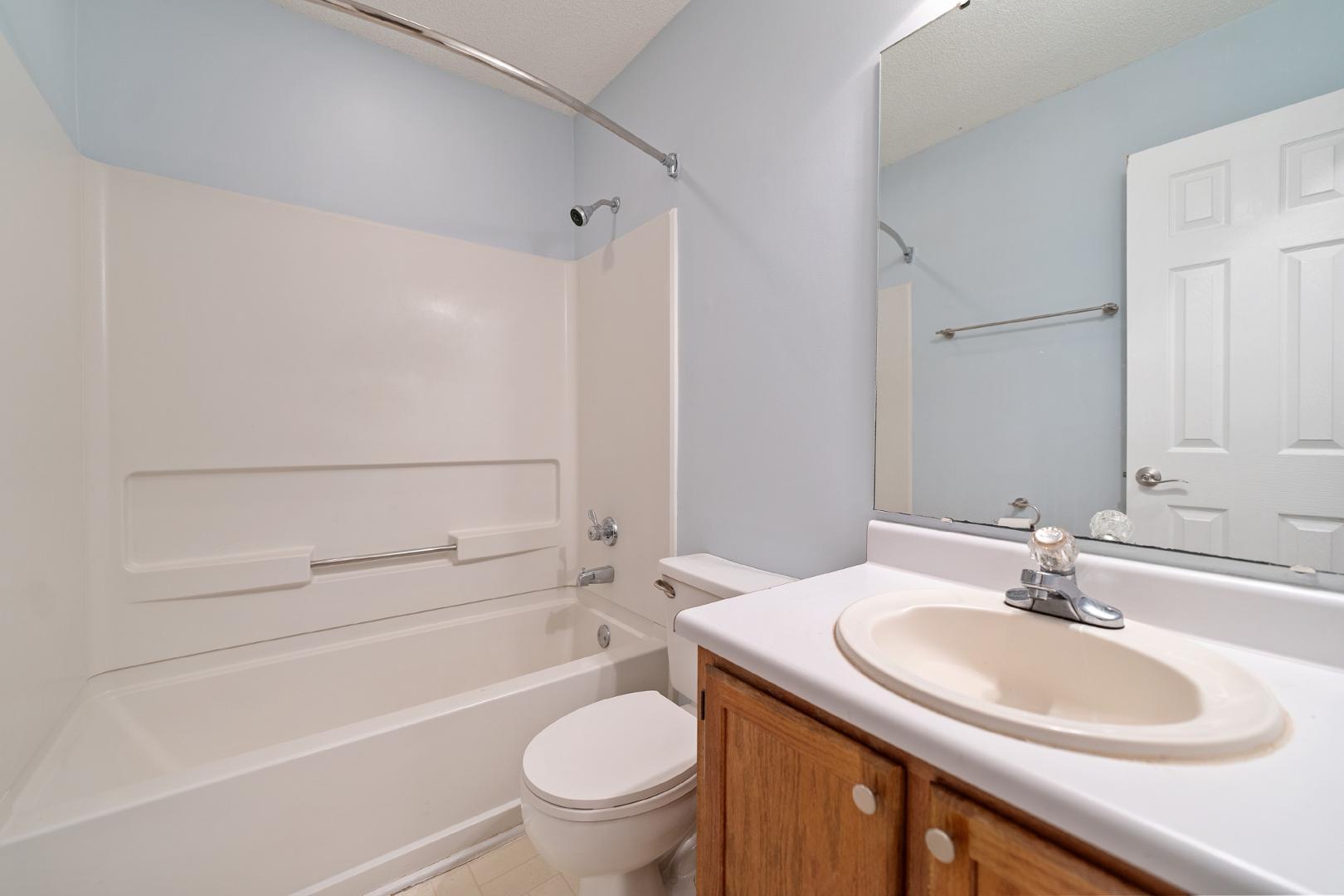 4111 Settlement Drive Durham, NC 27713 - Photo 12 of 16 a bathroom with a sink toilet vanity and shower