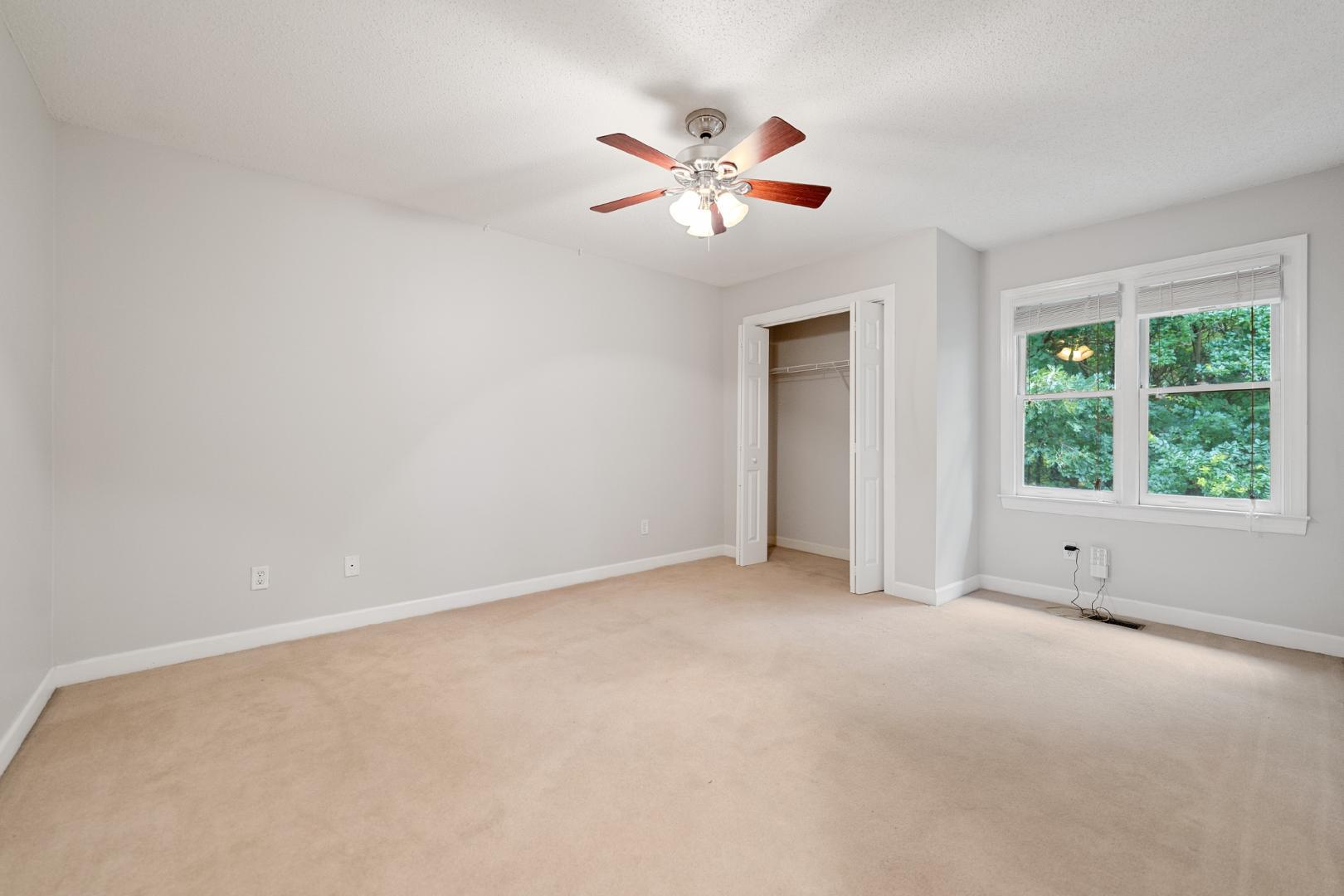 4111 Settlement Drive Durham, NC 27713 - Photo 13 of 16 an empty room with a window and a ceiling fan