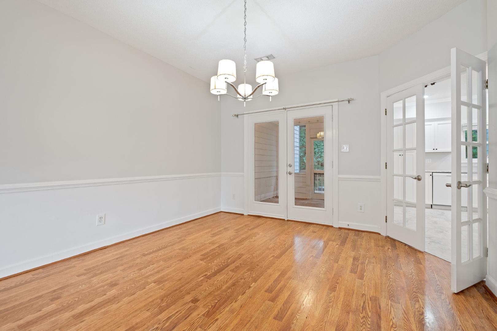 4111 Settlement Drive Durham, NC 27713 - Photo 5 of 16 a view of an empty room with wooden floor and a window