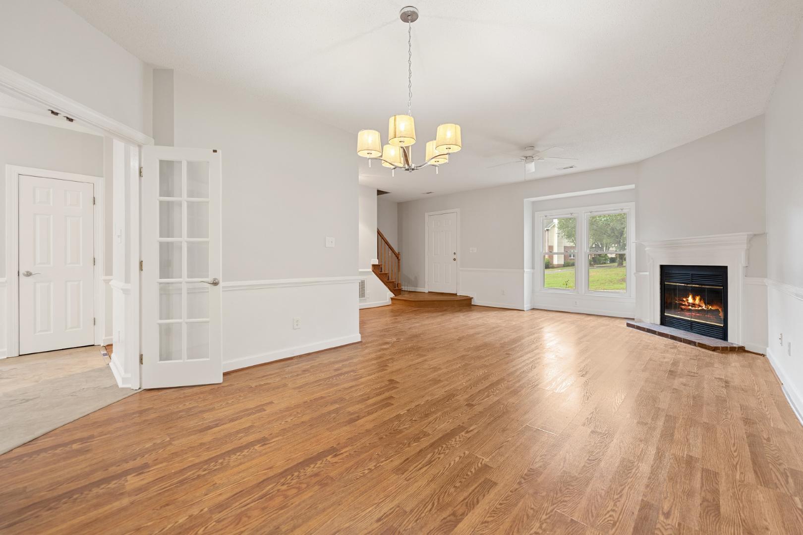 4111 Settlement Drive Durham, NC 27713 - Photo 6 of 16 a view of a room with wooden floor fireplace and window