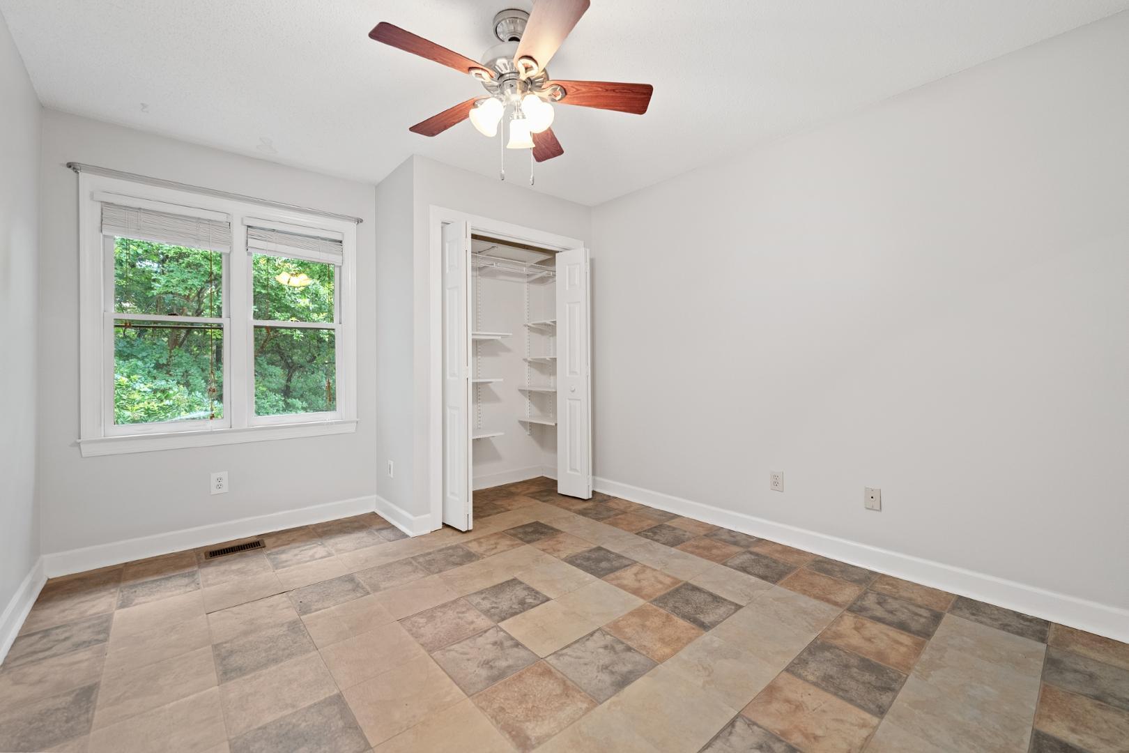 4111 Settlement Drive Durham, NC 27713 - Photo 7 of 16 an empty room with windows and fan