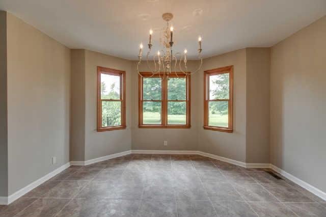 Dining open to kitchen and great room. Upgraded lighting.