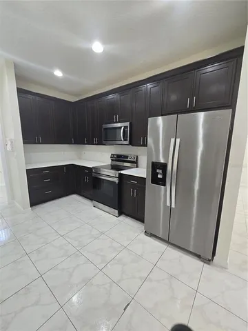 a kitchen with stainless steel appliances a refrigerator and a sink