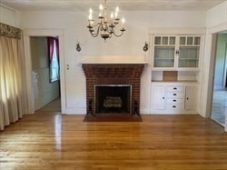 446 Chandler Street, Unit 2 Worcester, MA 01602 - Photo 5 of 11 a view of a livingroom with a fireplace a ceiling fan and window