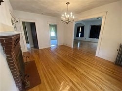 446 Chandler Street, Unit 2 Worcester, MA 01602 - Photo 6 of 11 a bedroom with a bed and a chandelier