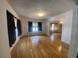 446 Chandler Street, Unit 2 Worcester, MA 01602 - Photo 7 of 11 a view of empty room with window and wooden floor