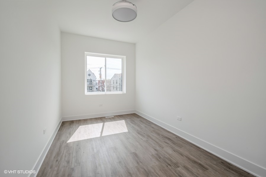 530 East 44th Place Chicago, IL 60653 - Photo 10 of 16 an empty room with wooden floor and windows