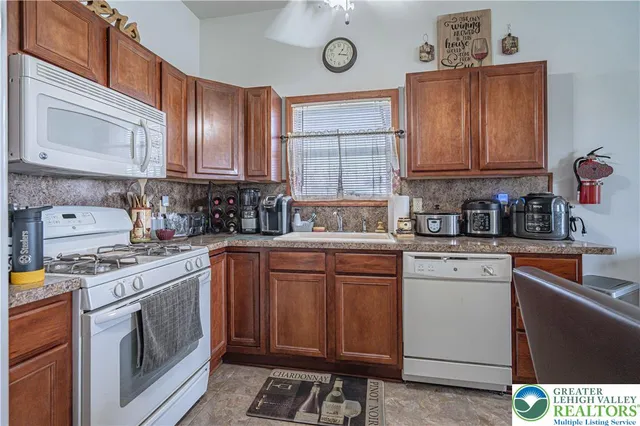 a kitchen with cabinets appliances and a sink