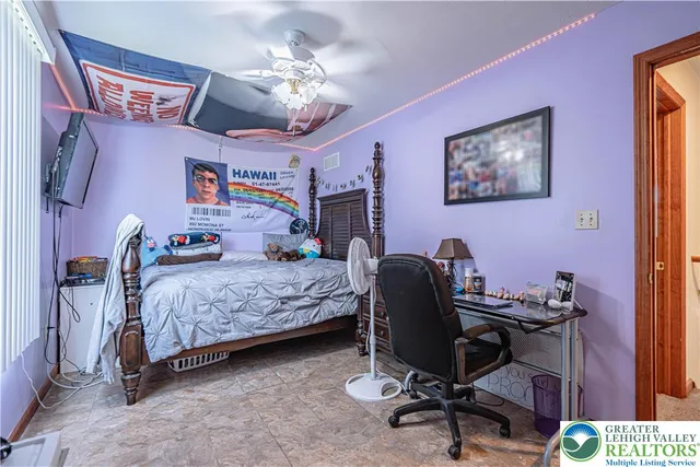 a bedroom with a large bed and a chandelier