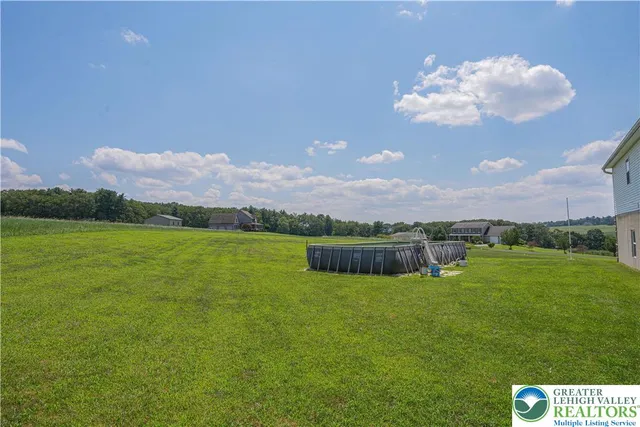 a view of a big house with a big yard