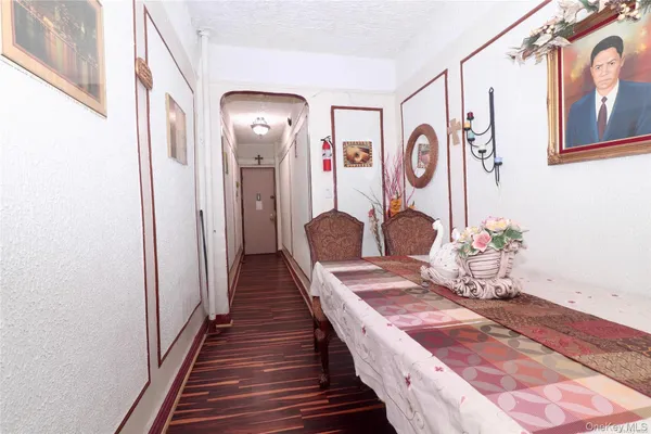 a bedroom with a bed and dresser with mirror