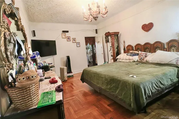 a bedroom with a bed and a chandelier