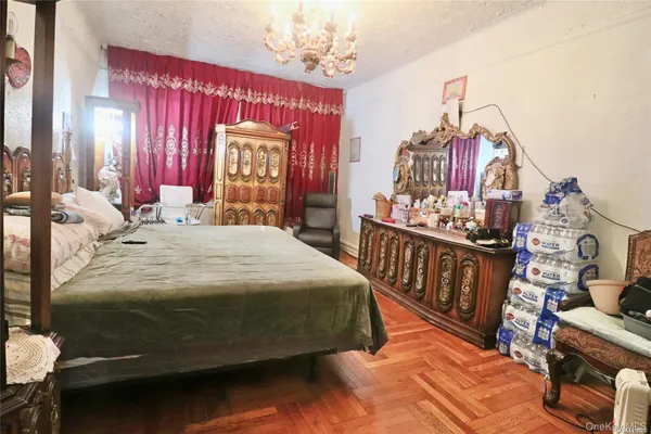 a bedroom with a bed and a dresser with mirror