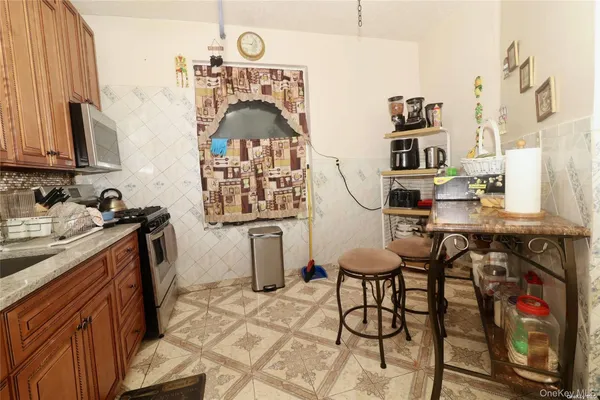 a view of a kitchen with fridge and window