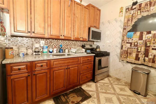 a kitchen with stainless steel appliances granite countertop a sink stove and microwave