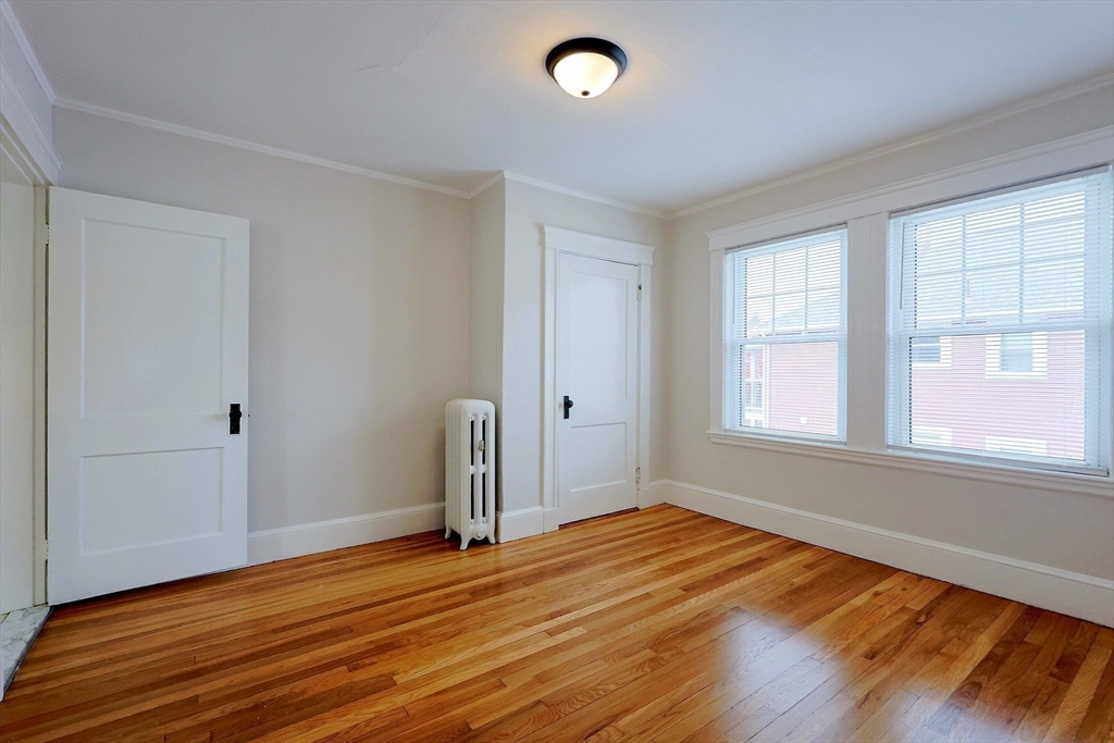 33 Woodleigh Road, Unit 2 Watertown, MA 02472 - Photo 11 of 23 an empty room with wooden floor and windows
