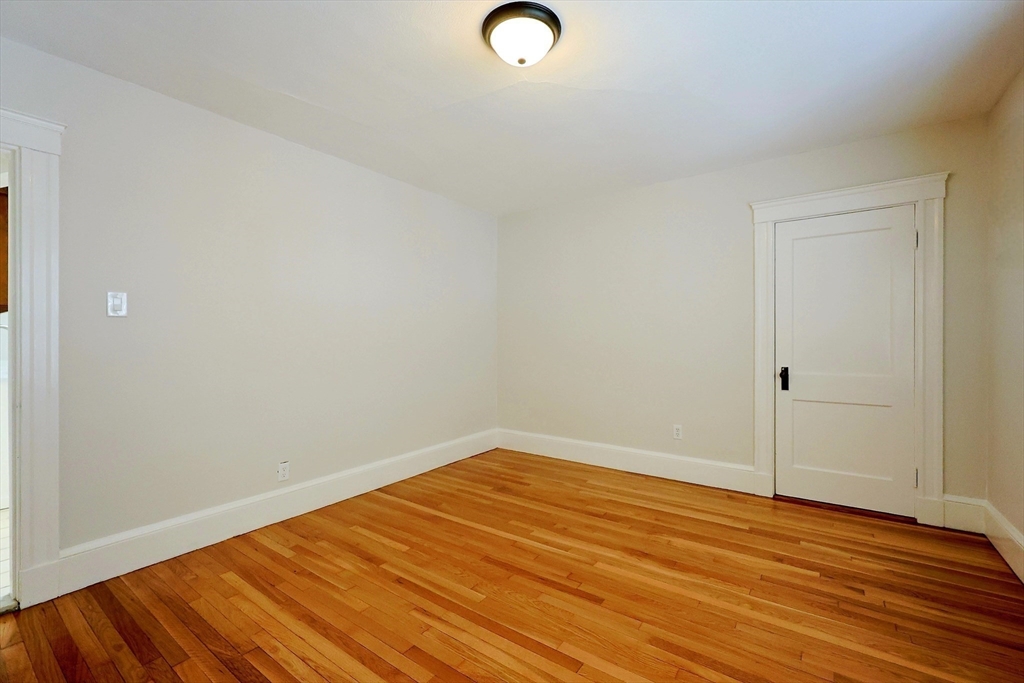 33 Woodleigh Road, Unit 2 Watertown, MA 02472 - Photo 14 of 23 a view of empty room with wooden floor