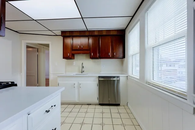 a kitchen with a sink cabinets and window