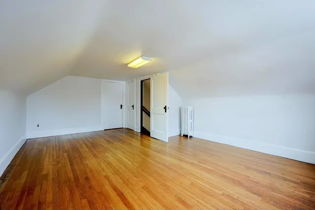 a view of an empty room and wooden floor