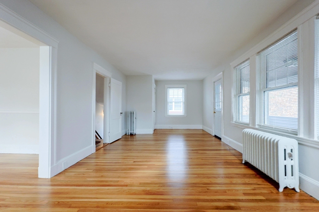 33 Woodleigh Road, Unit 2 Watertown, MA 02472 - Photo 5 of 23 a view of an empty room with wooden floor and a window