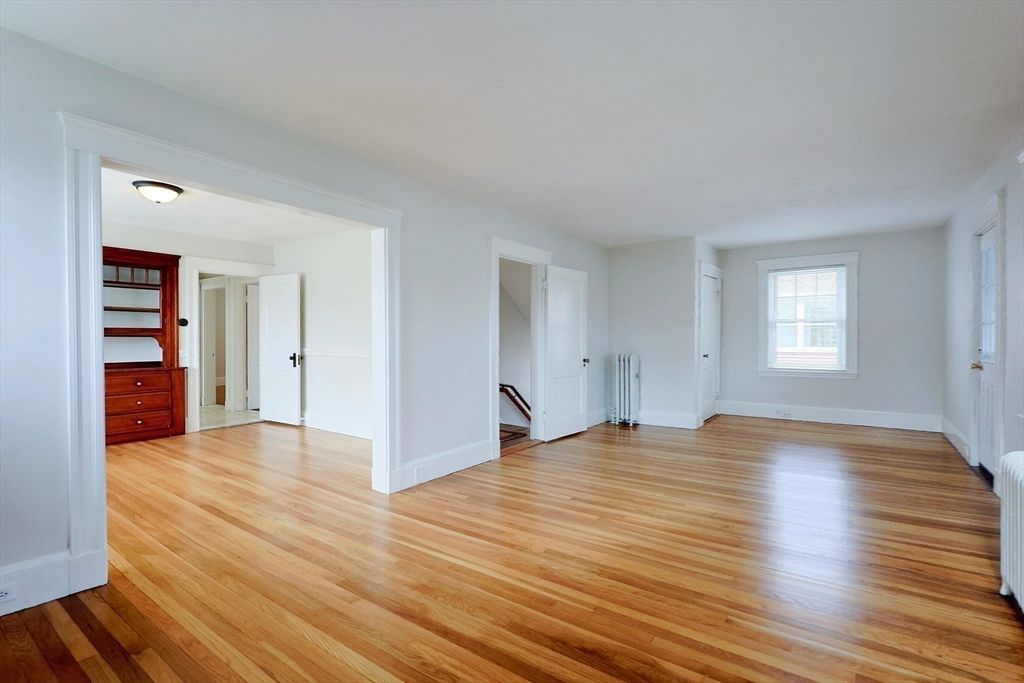 33 Woodleigh Road, Unit 2 Watertown, MA 02472 - Photo 6 of 23 a view of empty room with wooden floor and window