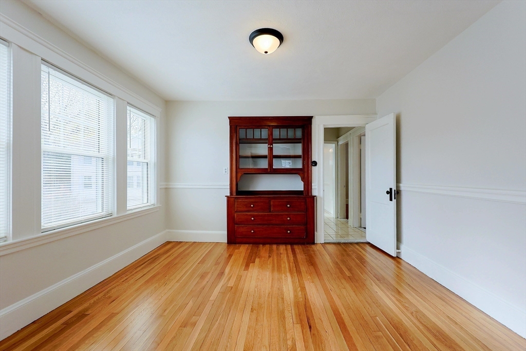 33 Woodleigh Road, Unit 2 Watertown, MA 02472 - Photo 8 of 23 an empty room with wooden floor closet and windows