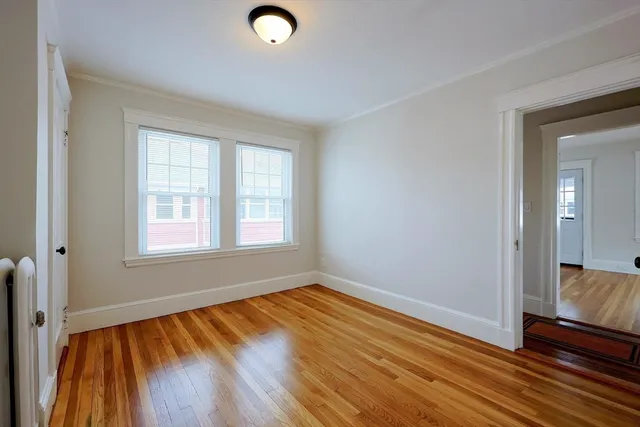 a view of a room with wooden floor and window