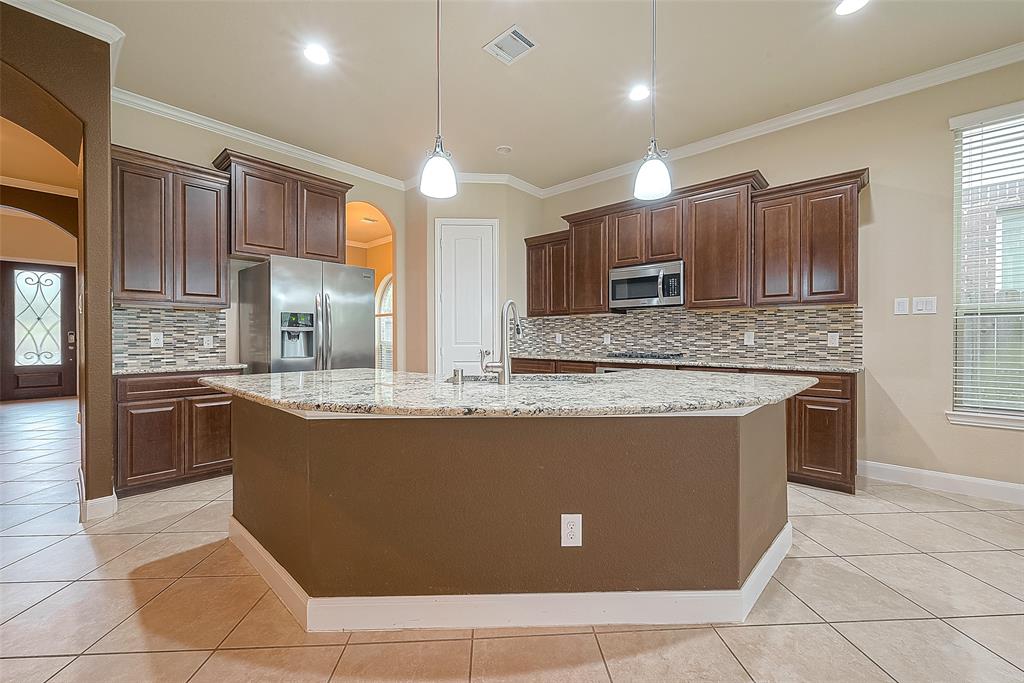 a view of kitchen with stainless steel appliances granite countertop a sink and a stove