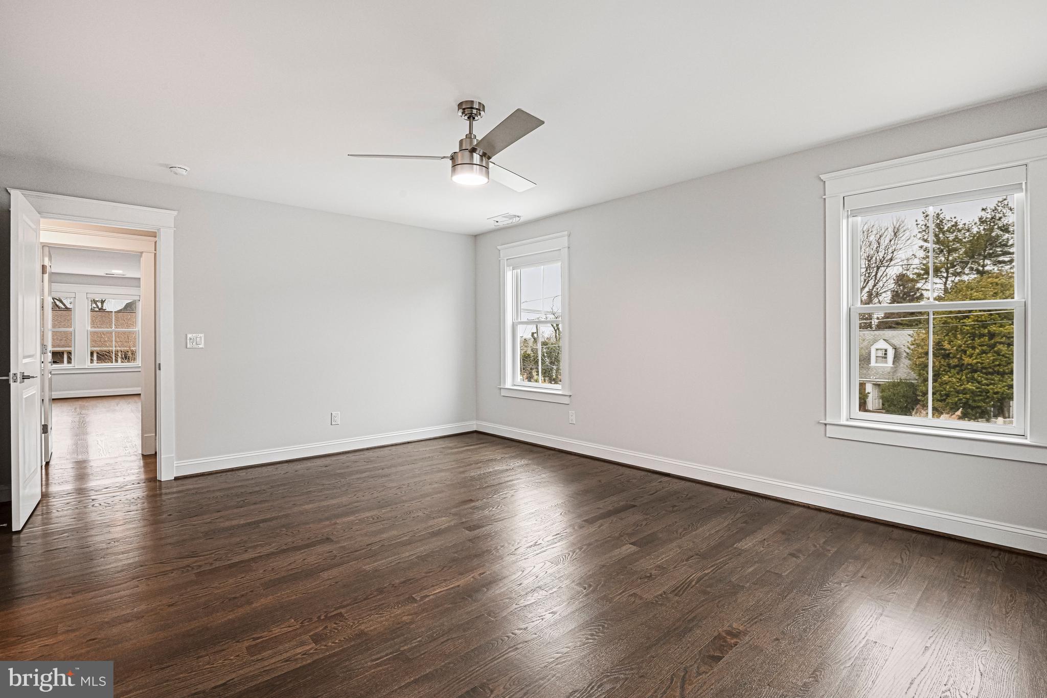 6447 Tucker Avenue McLean, VA 22101 - Photo 20 of 47 an empty room with wooden floor chandelier fan and windows