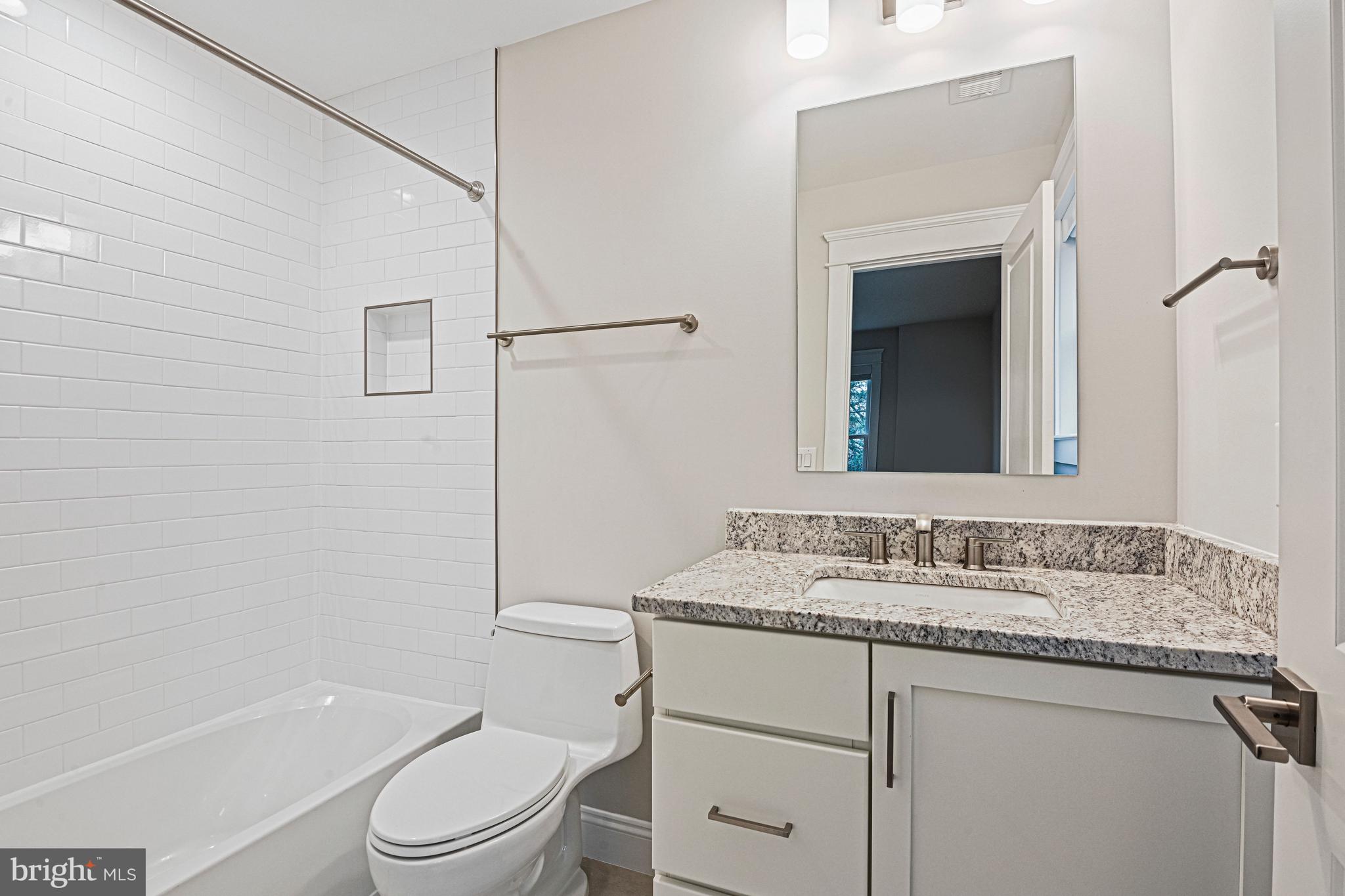 6447 Tucker Avenue McLean, VA 22101 - Photo 25 of 47 a bathroom with a granite countertop sink toilet and shower