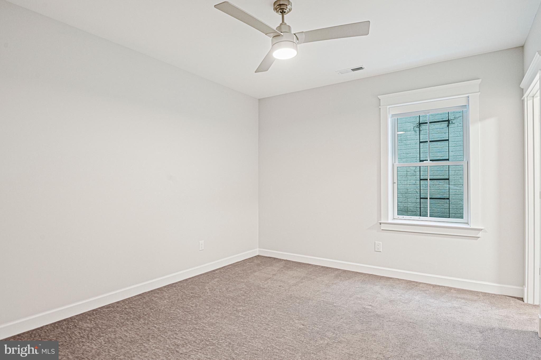 6447 Tucker Avenue McLean, VA 22101 - Photo 33 of 47 an empty room with a window and ceiling fan