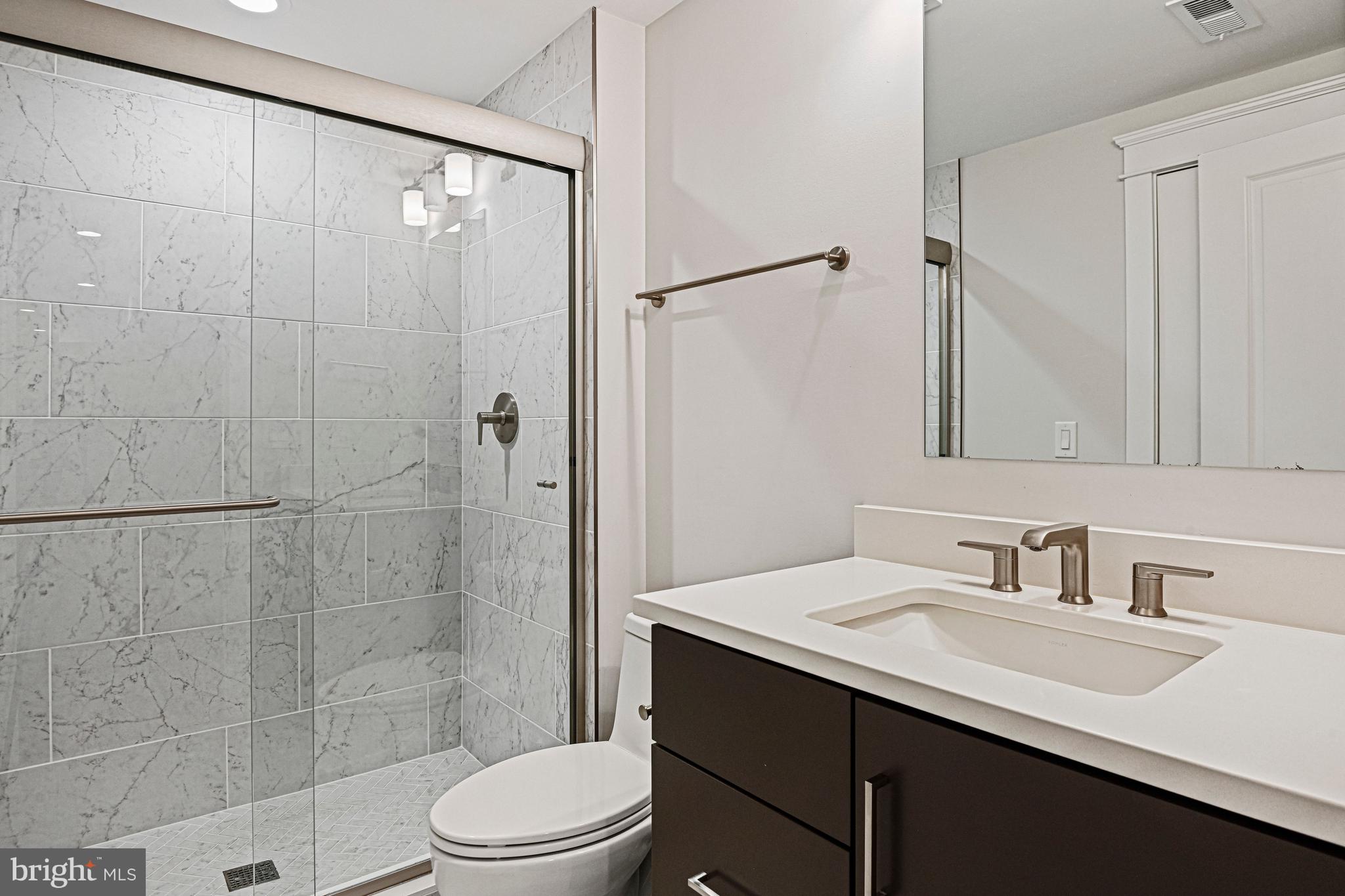 6447 Tucker Avenue McLean, VA 22101 - Photo 36 of 47 a bathroom with a sink toilet and shower