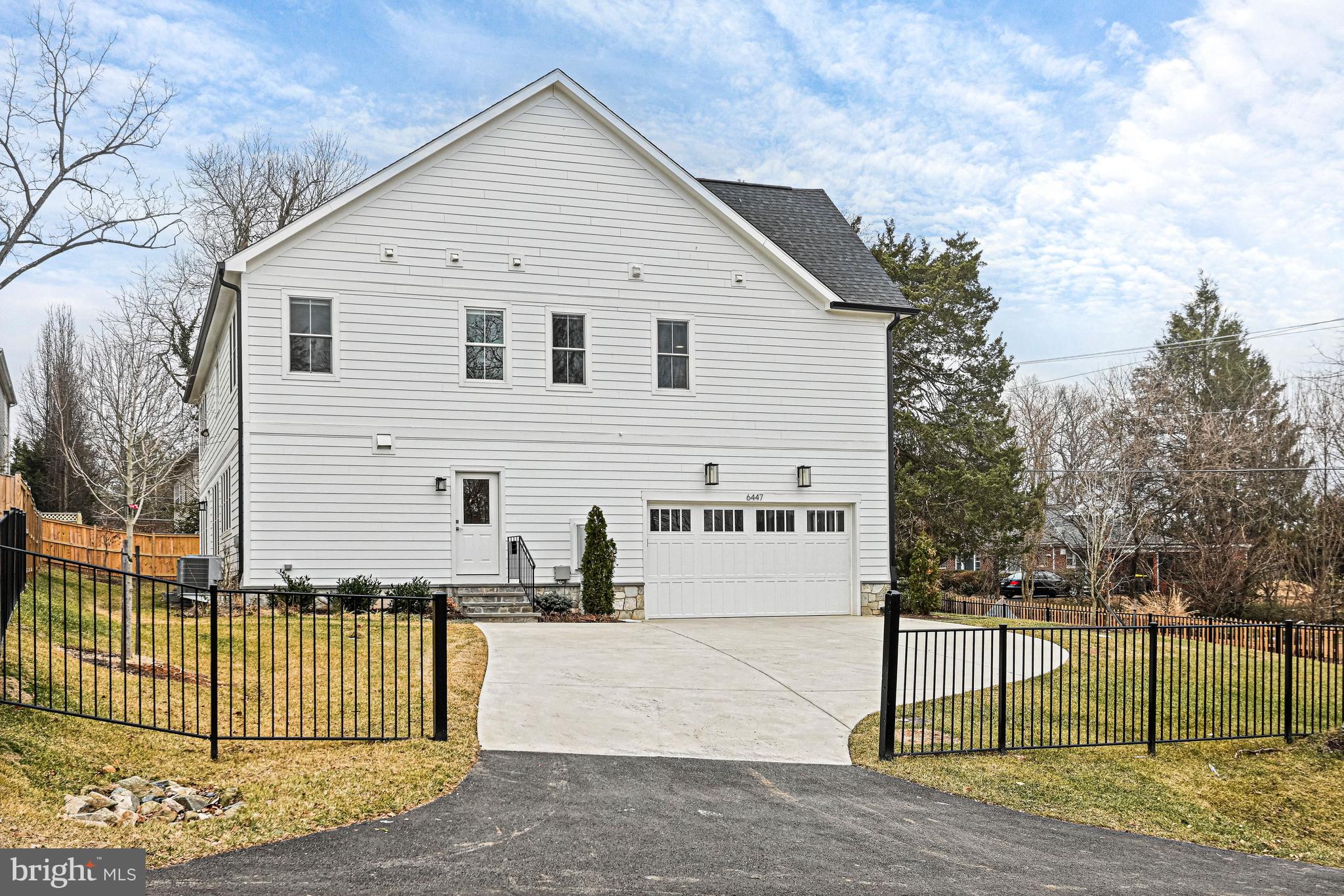 6447 Tucker Avenue McLean, VA 22101 - Photo 40 of 47 a view of a white house with a small yard and wooden fence