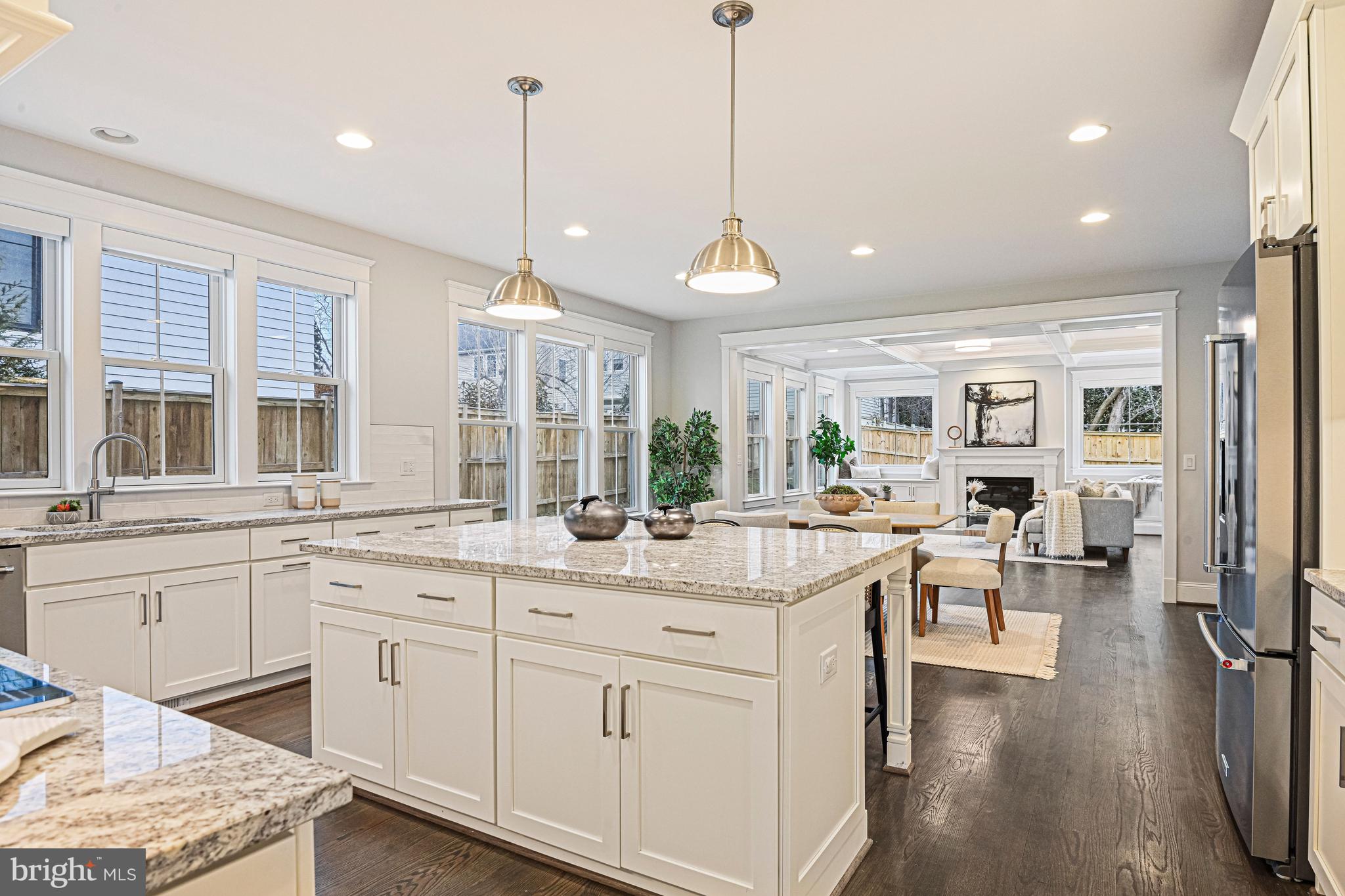 6447 Tucker Avenue McLean, VA 22101 - Photo 4 of 47 a open kitchen with kitchen island white cabinets and white appliances