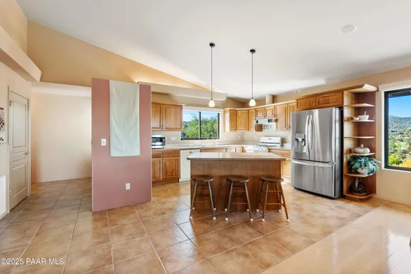 a kitchen with a refrigerator a oven and a sink