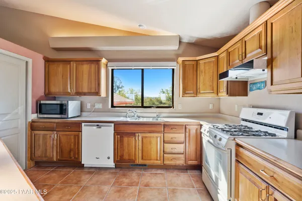 a kitchen with stainless steel appliances granite countertop a sink and cabinets