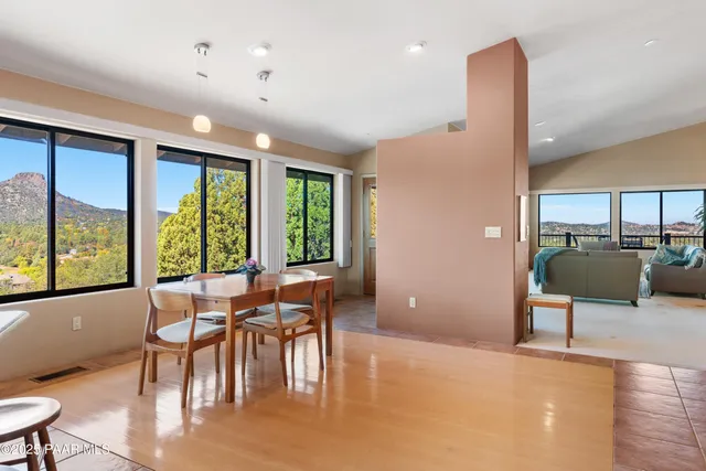 a living room with furniture and large windows