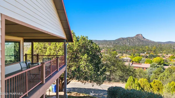 a view of a chairs and table in the balcony