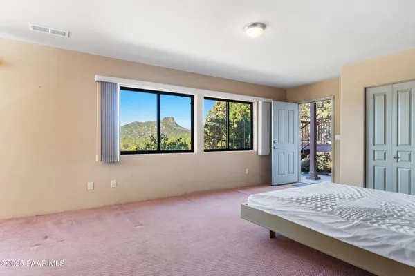 a bed sitting in a bedroom next to a window
