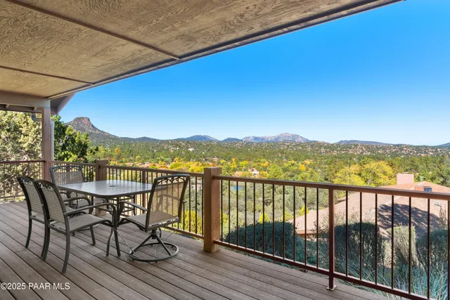 a view of a city from a balcony with furniture