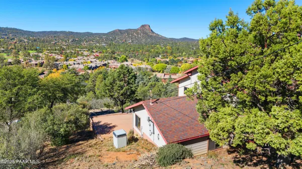 an aerial view of a house with a yard