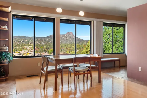 a dining room with furniture window and wooden floor