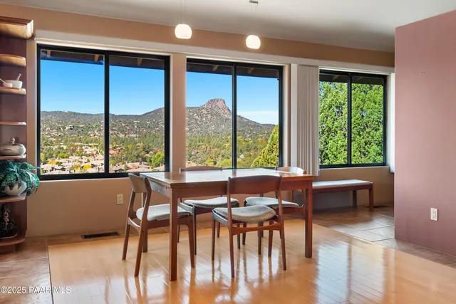 a dining room with furniture window and wooden floor