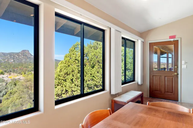 a bedroom with furniture and a large window
