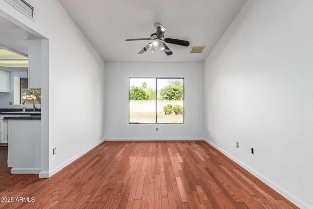 a kitchen with granite countertop stainless steel appliances a sink window and cabinets